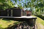 Flot beliggende sommerhus i Krakær – Vildmarksbad og lækker udsigt til 8 personer